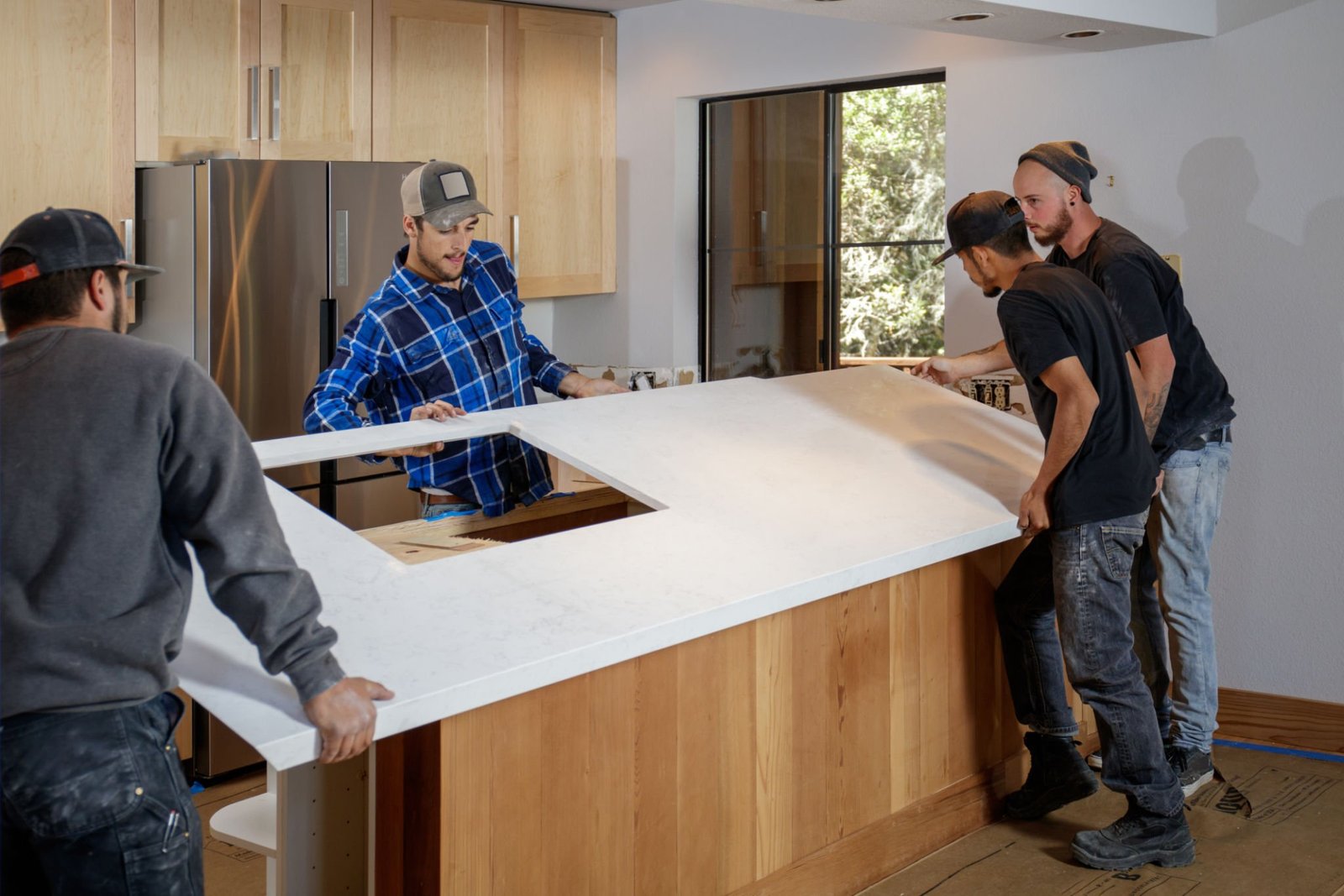 Kitchen remodel - men installing quartz worktops